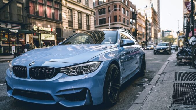 blue BMW coupe parked on the road during daytime