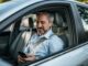 Man using phone while sitting in the car.